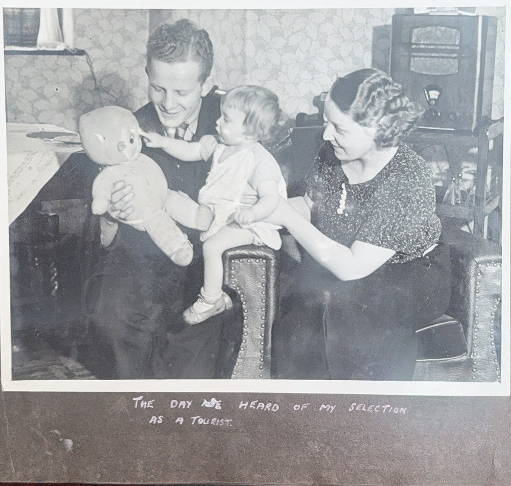 Album page: Emlyn and Kathleen Jenkins with baby Patricia, captioned The day we heard of my selection as a tourist