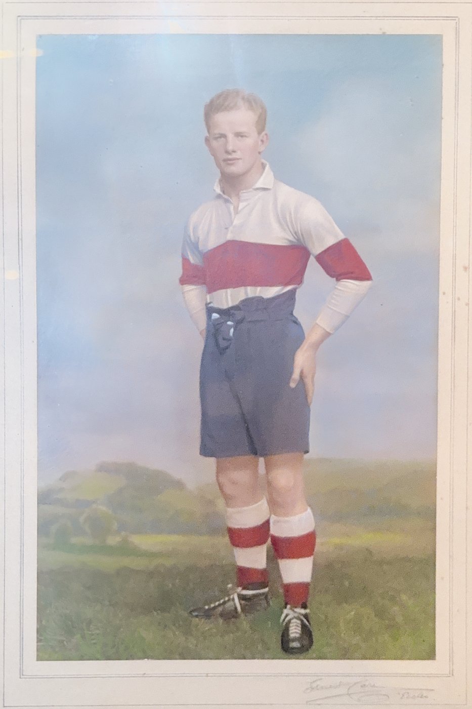 Hand-tinted studio portrait of Emlyn Jenkins in rugby kit, believed to be his Glamorgan county colours